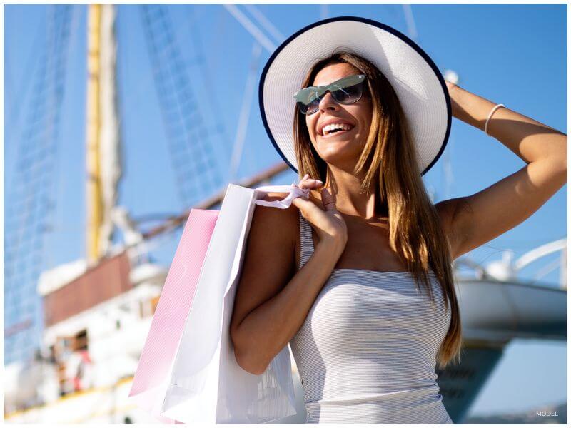 Woman enjoying results of her financed plastic surgery with a confident smile”