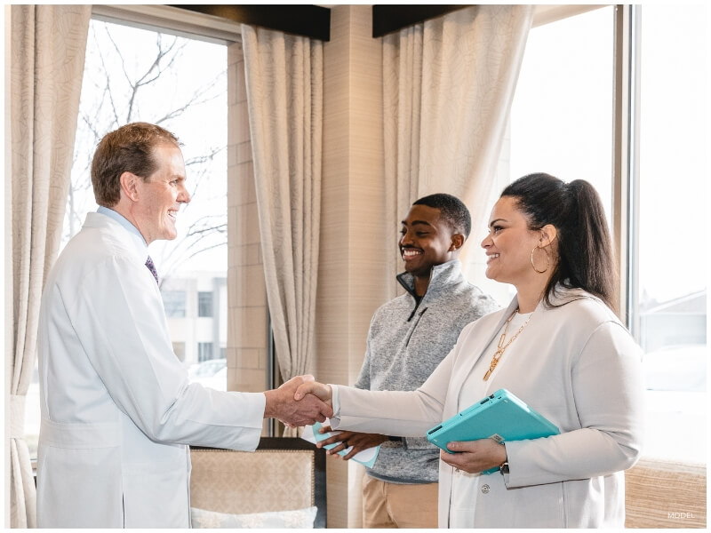 couple meeting with surgeon after making a decision to finance plastic surgery
