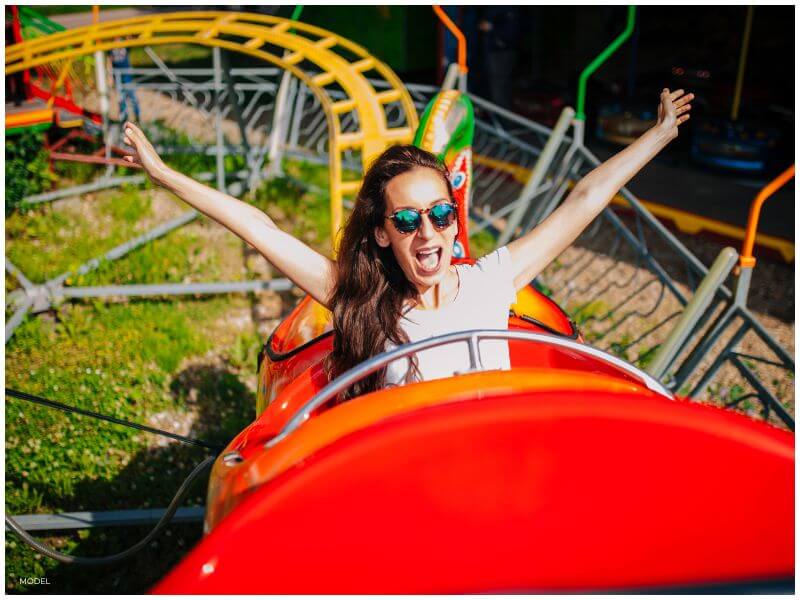 woman on roller coaster showing a depiction of the variable emotions that patients experience leading up to tummy tuck surgery