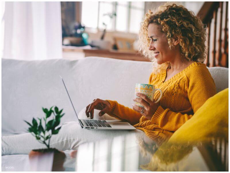 woman on her lap top researching tummy tuck surgery showing how important adequate preparation can be leading up to plastic surgery