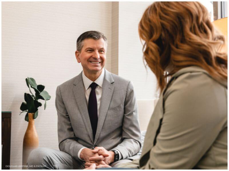 proprietary image showing Douglas Leppink, MD consulting with a model representing a patient